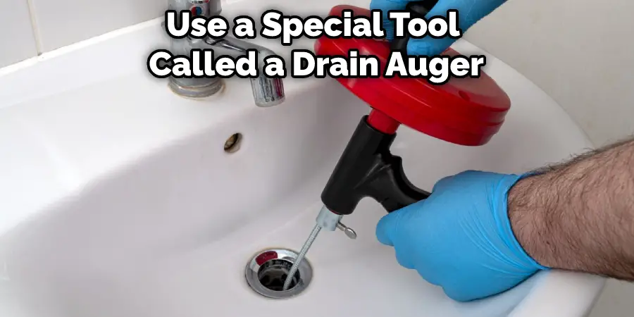 Use a Special Tool Called a Drain Auger