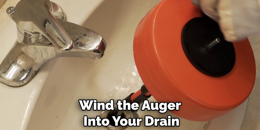 Wind the Auger Into Your Drain