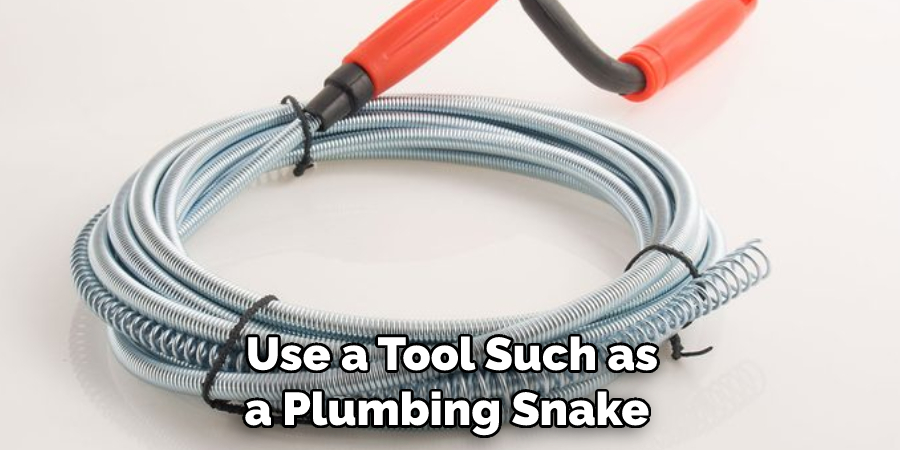 Use a Tool Such as a Plumbing Snake