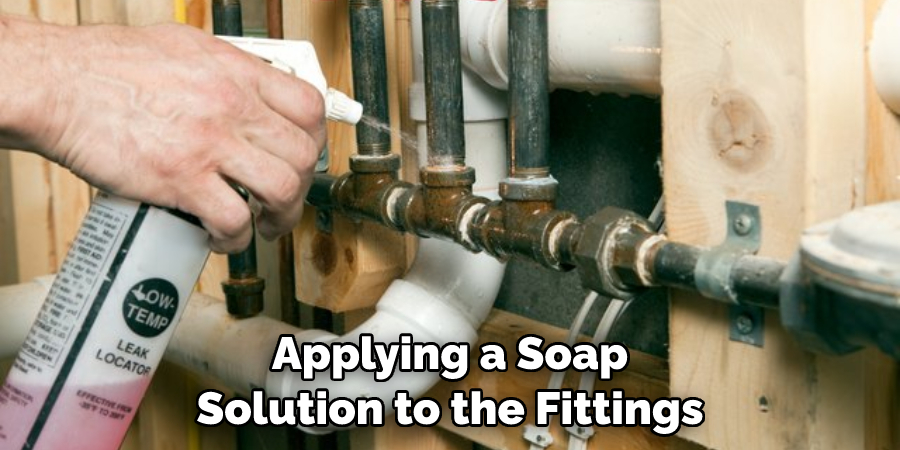 Applying a Soap Solution to the Fittings