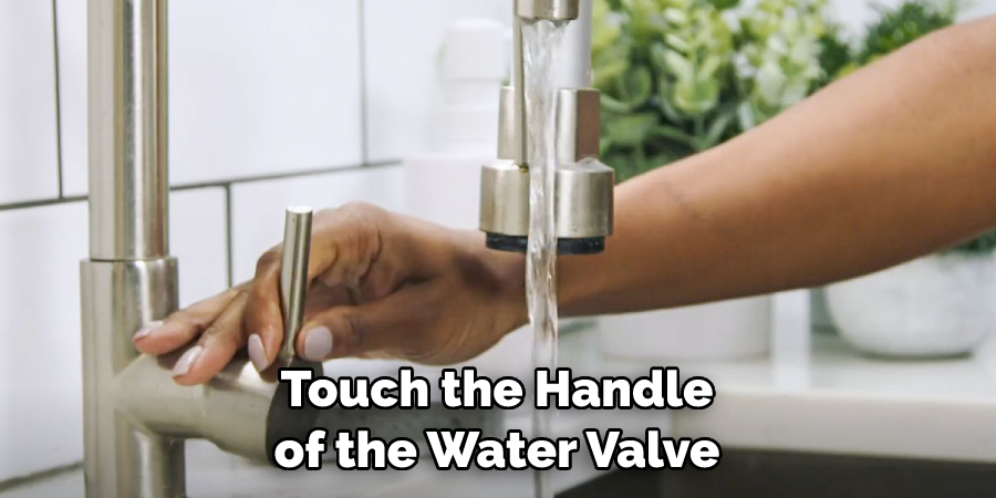 Touch the Handle of the Water Valve