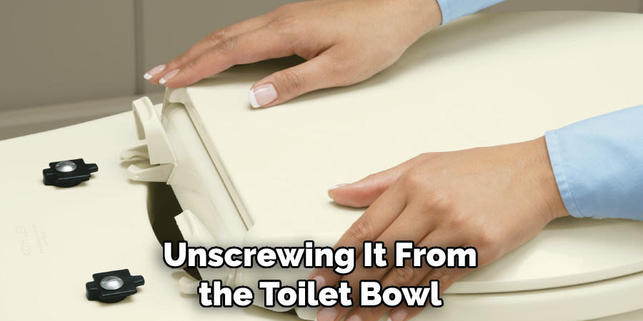 Unscrewing It From the Toilet Bowl