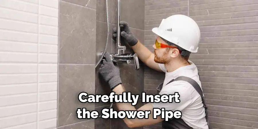 Carefully Insert the Shower Pipe