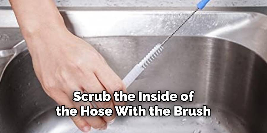 Scrub the Inside of the Hose With the Brush