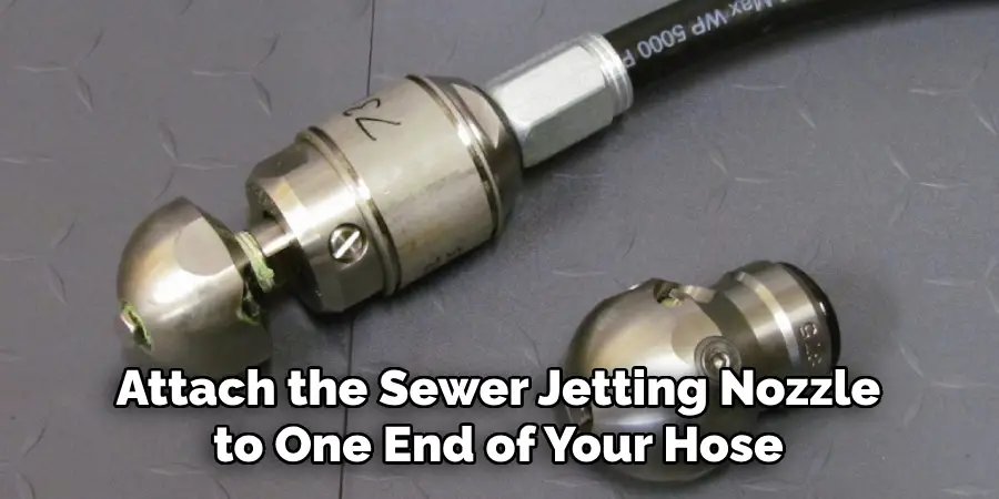 Attach the Sewer Jetting Nozzle to One End of Your Hose