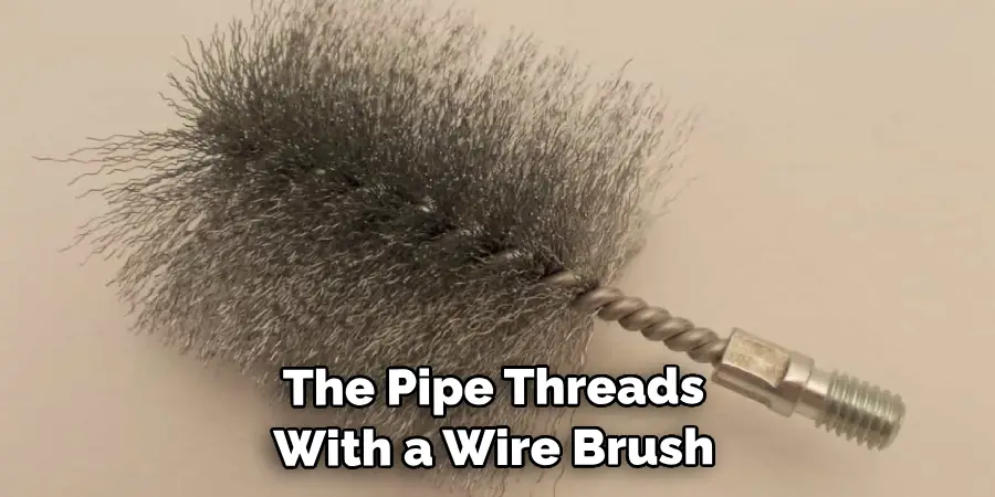 The Pipe Threads With a Wire Brush