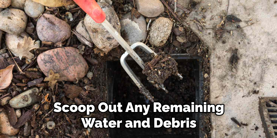 Scoop Out Any Remaining Water and Debris