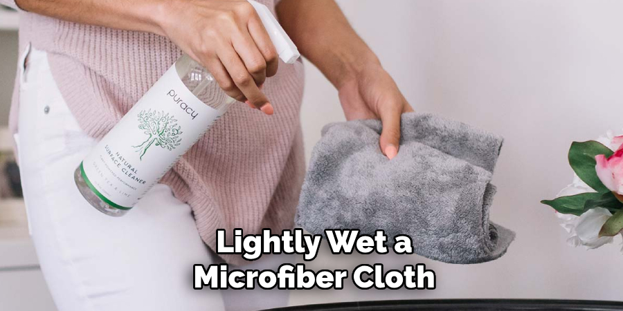 Lightly Wet a
Microfiber Cloth