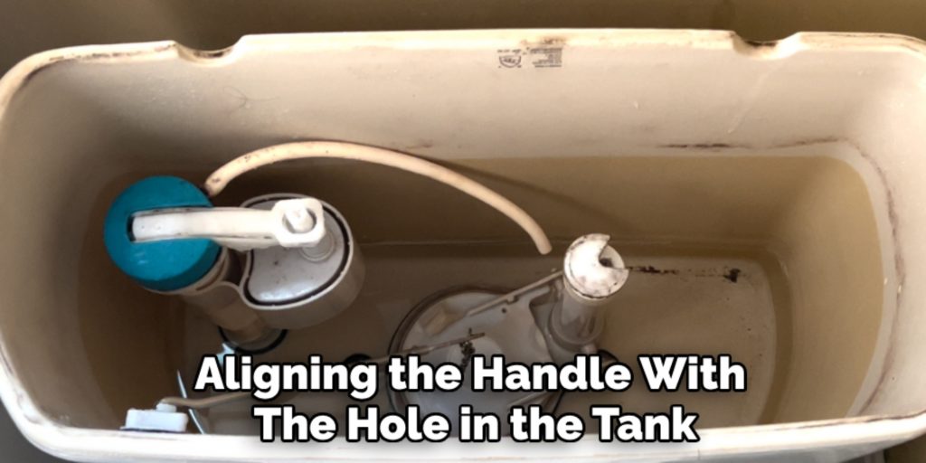 Aligning the Handle With 
The Hole in the Tank