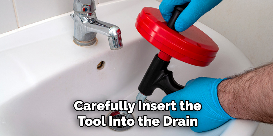 Carefully Insert the
Tool Into the Drain