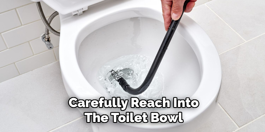 Carefully Reach Into
The Toilet Bowl