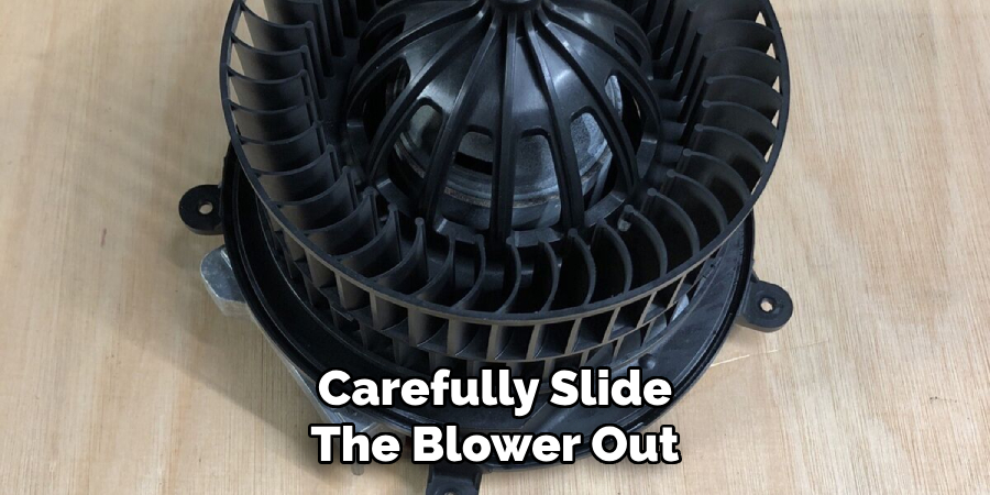 Carefully Slide
The Blower Out