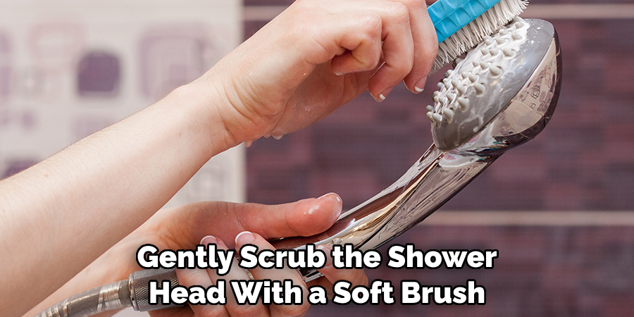 Gently Scrub the Shower Head With a Soft Brush