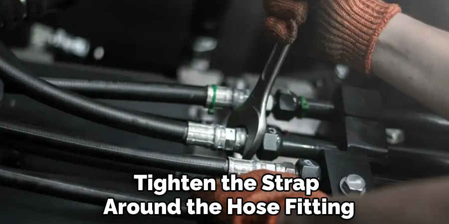 Tighten the Strap 
Around the Hose Fitting