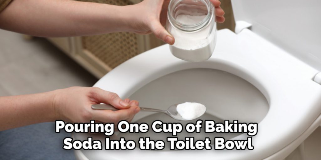 pouring one cup of baking soda into the toilet bowl