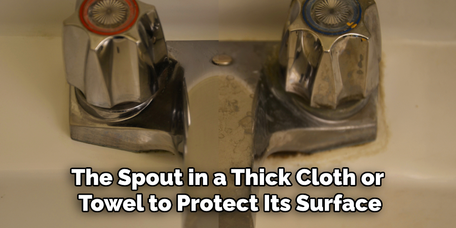 The Spout in a Thick Cloth or
Towel to Protect Its Surface