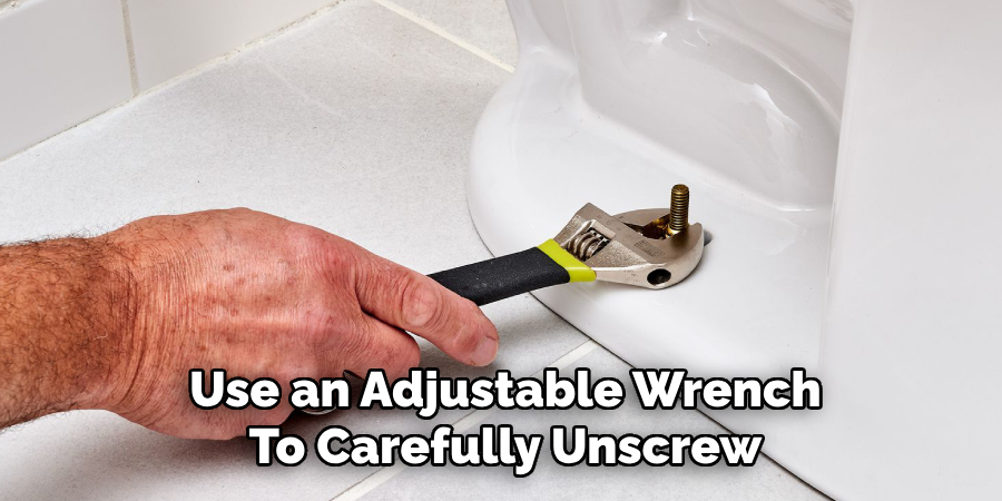 Use an Adjustable Wrench
To Carefully Unscrew