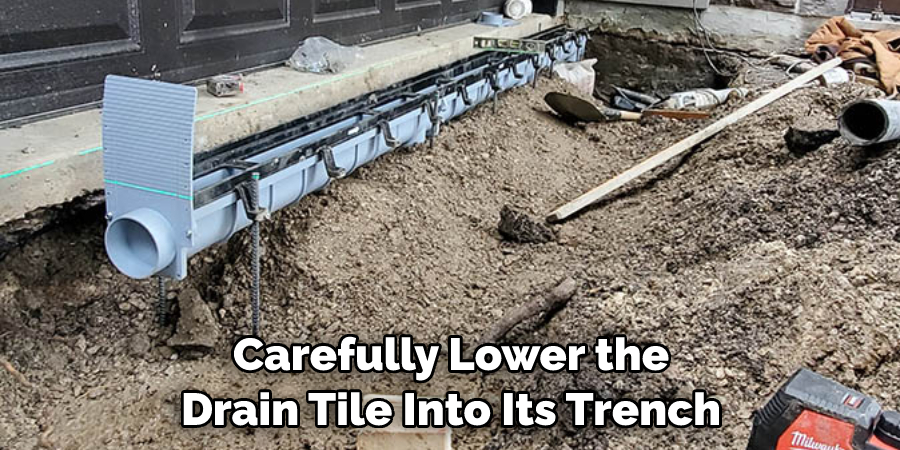 Carefully Lower the Drain Tile Into Its Trench